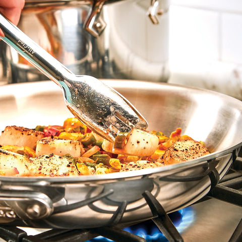 All-Clad specialty tongs pair with cookware for versatile serving and gripping tasks.