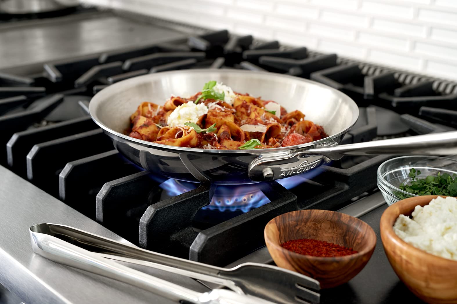 All-Clad stainless steel tongs shine with a mirror polish and ergonomic handle.
