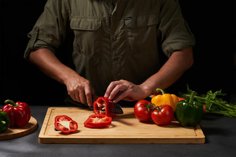 Allsum cutting board shows deep juice grooves to catch spills.