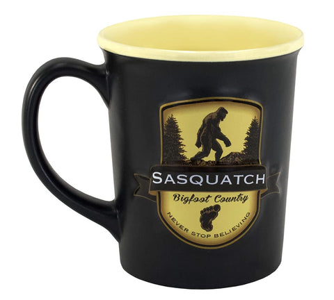 Americaware Bigfoot emblem mug with rugged forest scene for outdoor coffee rituals.