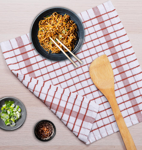 AMOUR INFINI dishcloths folded on a drying rack for storage.