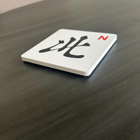 Artful 3D Mahjong coasters close-up; cork backing and stable base.