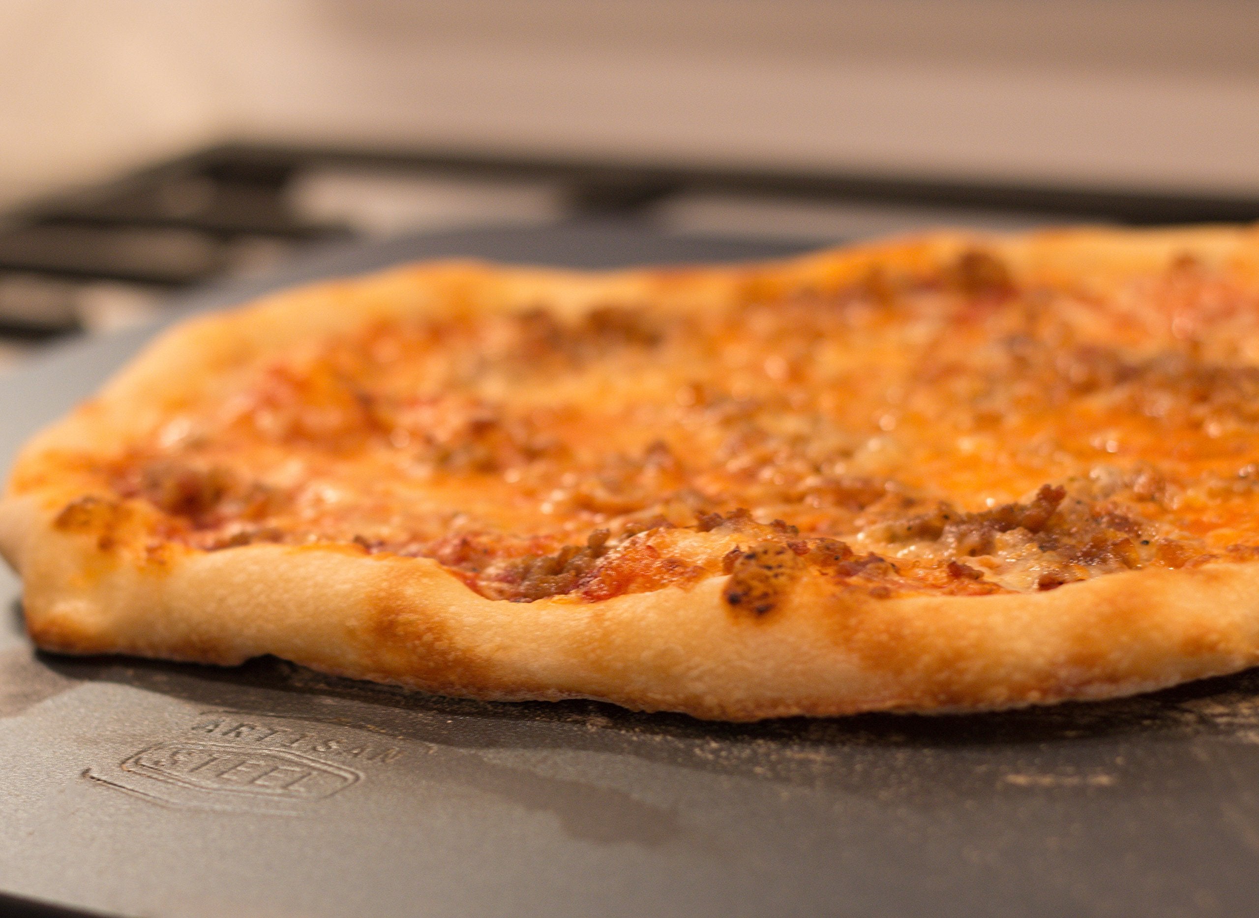 Artisan Steel pizza steel closeup conductivity highlighting fast heat response.