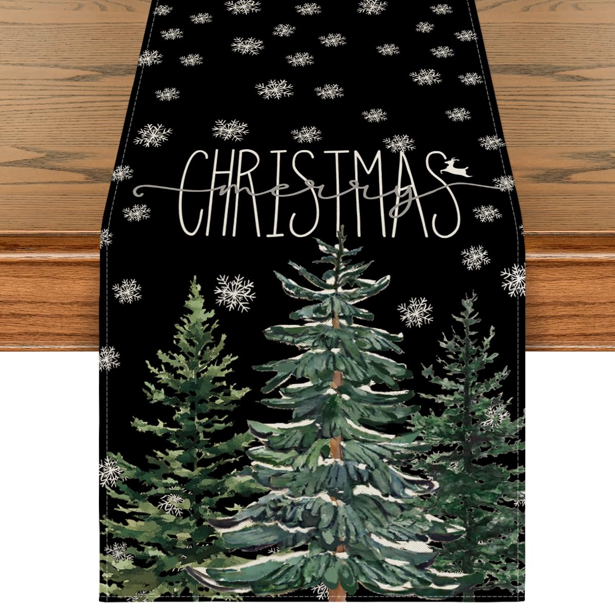 Artoid Mode table runner with black pine snowflake pattern for festive gatherings.