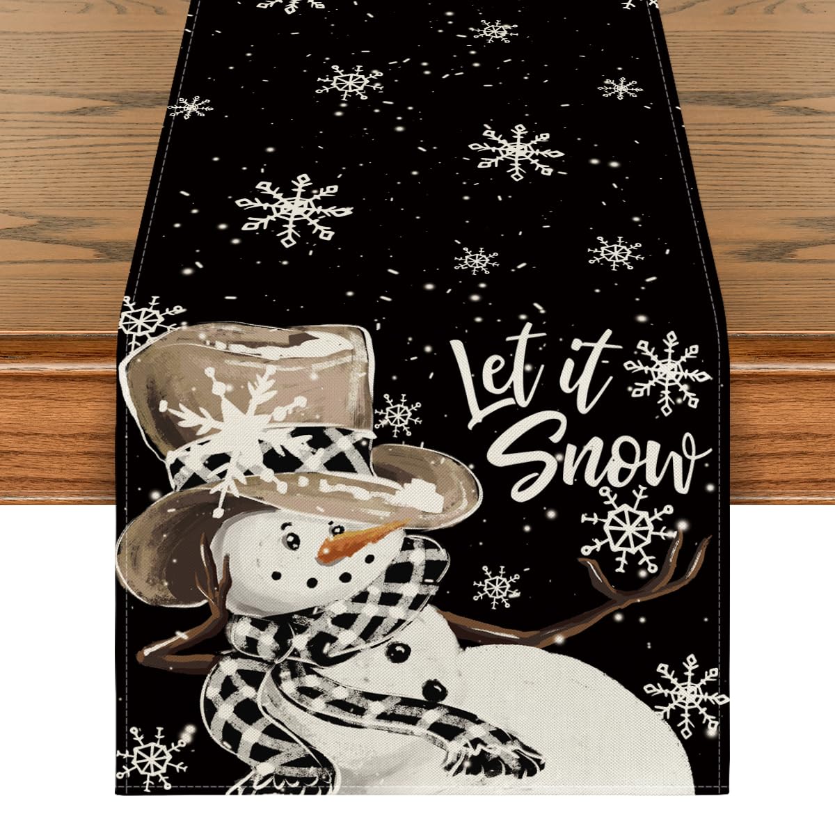 Artoid Mode black snowman snowflake table runner on dining table, protecting surfaces and elevating holiday dining.