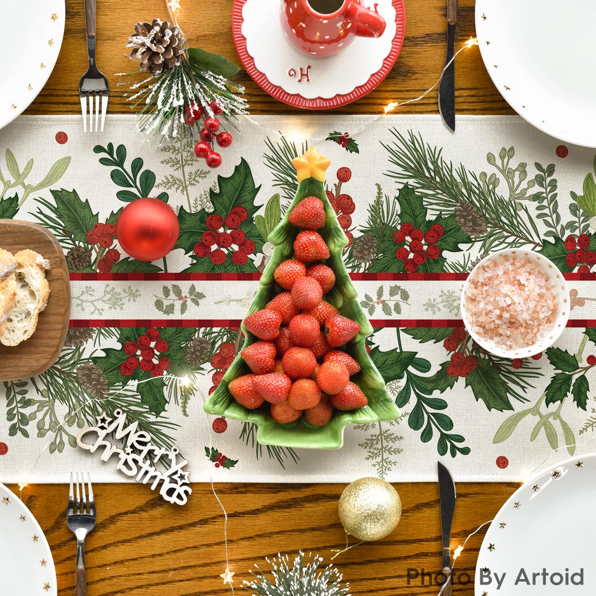 Artoid Mode holly pine cone leaves floral runner in a warm seasonal dining scene