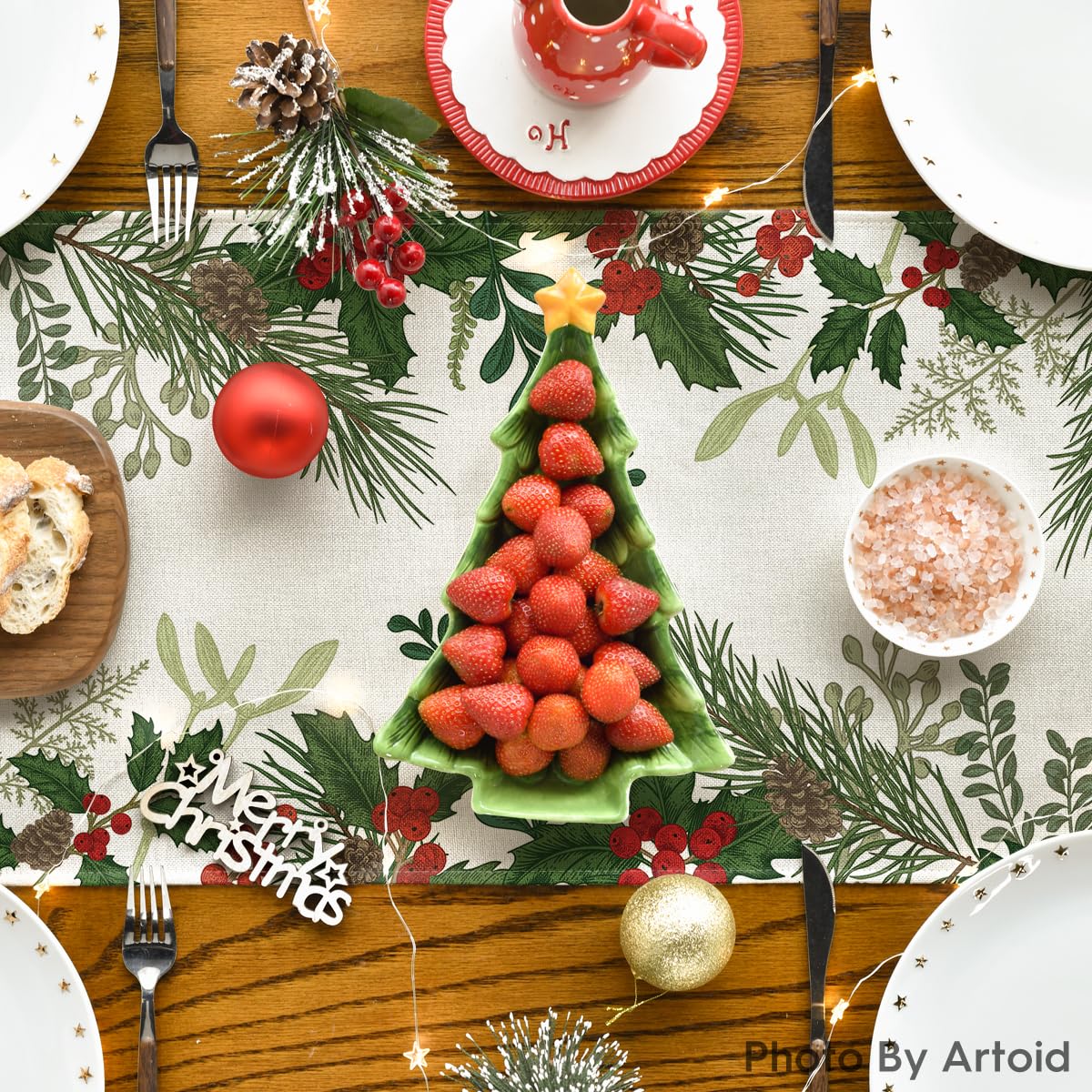 Artoid Mode holly pine cone on winter table image conveys festive ambiance for gatherings.