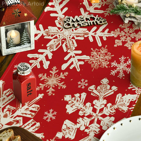 Artoid Mode table runner showcases vibrant red snowflakes for cozy winter gatherings.