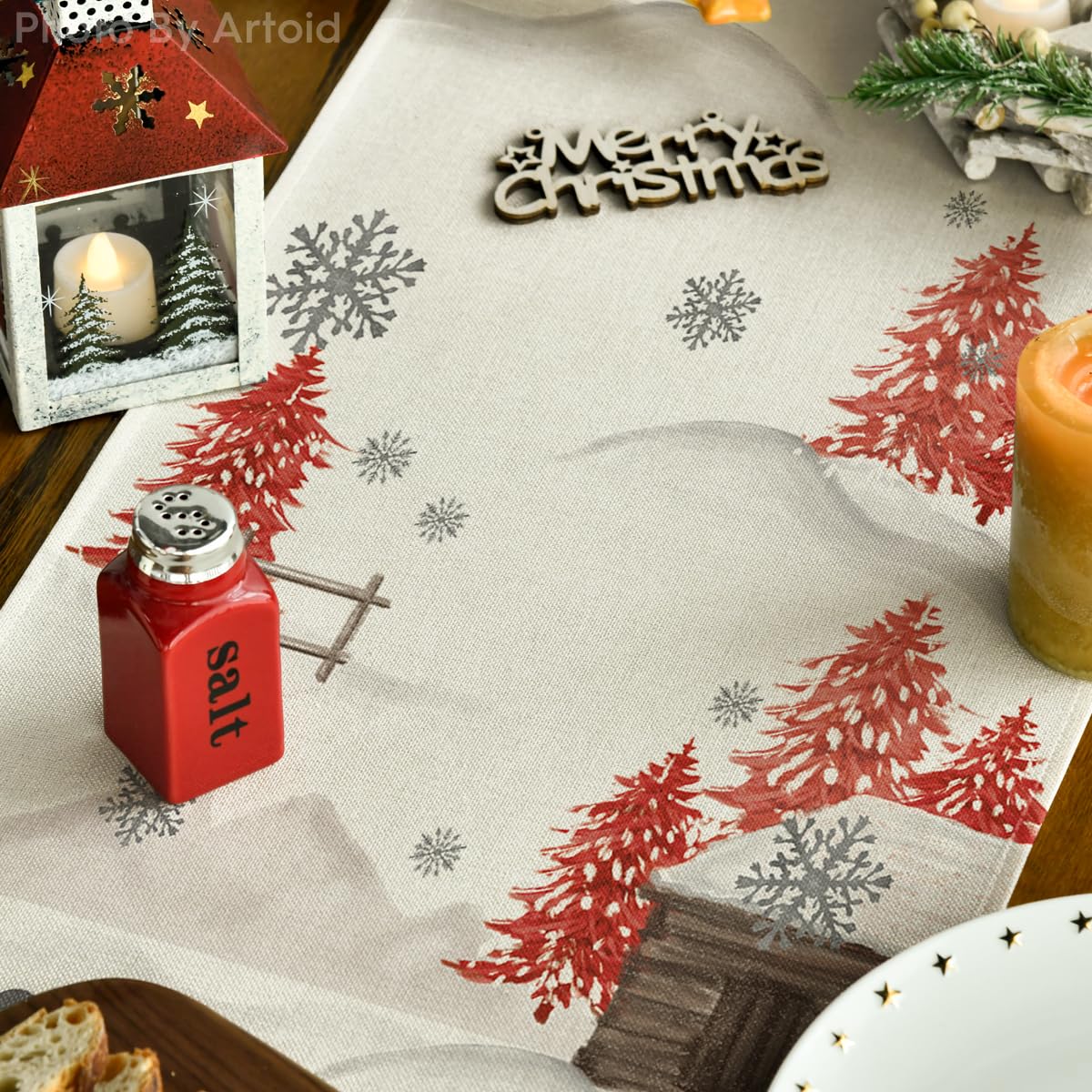 Artoid Mode Xmas Trees Let It Snow table runner on wood surface highlights durable, spill-resistant material.