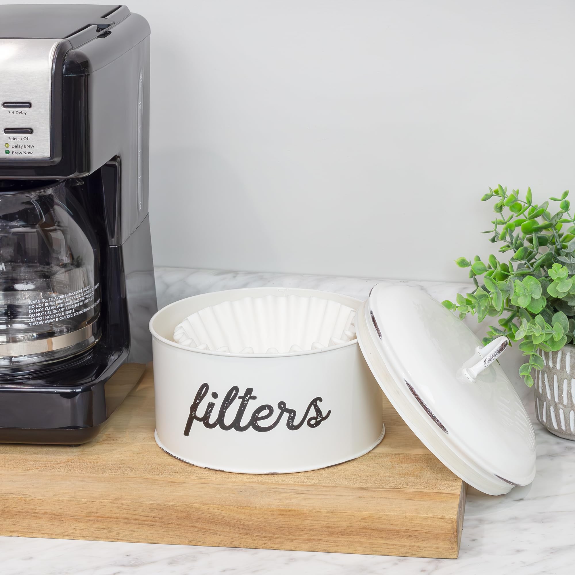 AuldHome Design filter storage on shelf enhances farmhouse aesthetics and organization.