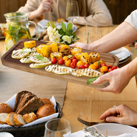 Ayiaren acacia tray with deep edges catching juices during serving.