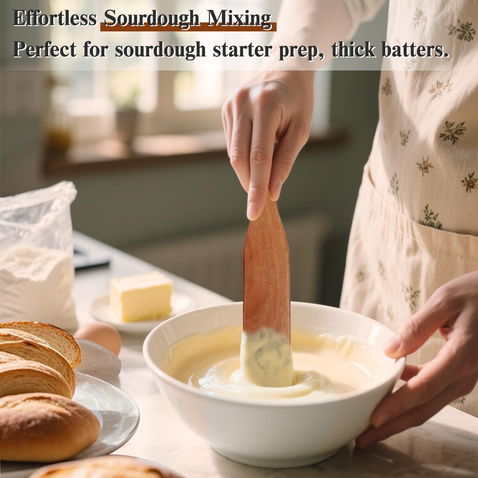 Azureblue spurtle spreading butter in a warm nonstick skillet