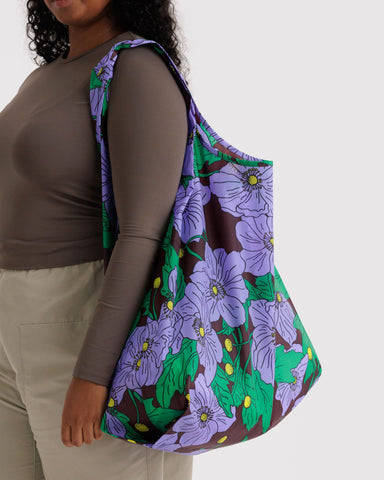 BAGGU Amazon Florals tote folded into the compact pouch for easy packing.