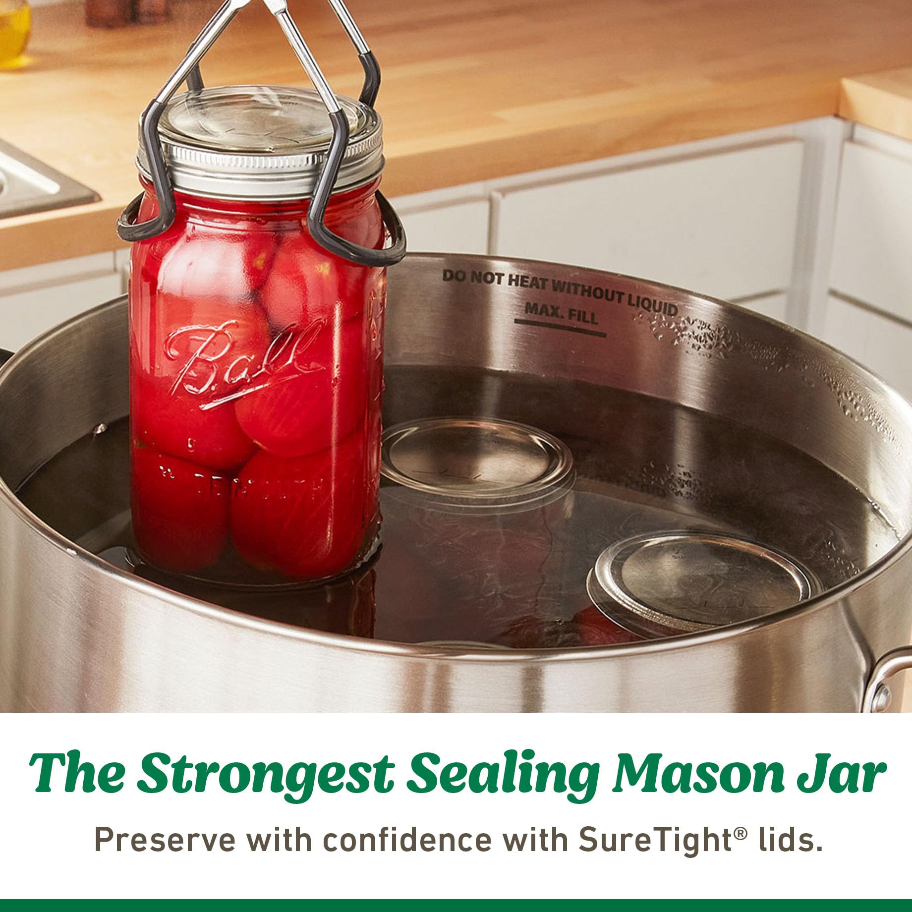 Ball Mason jar lids pictured with clear jar ready for canning