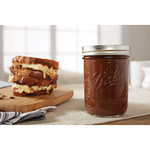 Ball mason jar with lids in closeup, showing sealing band and glass clarity.