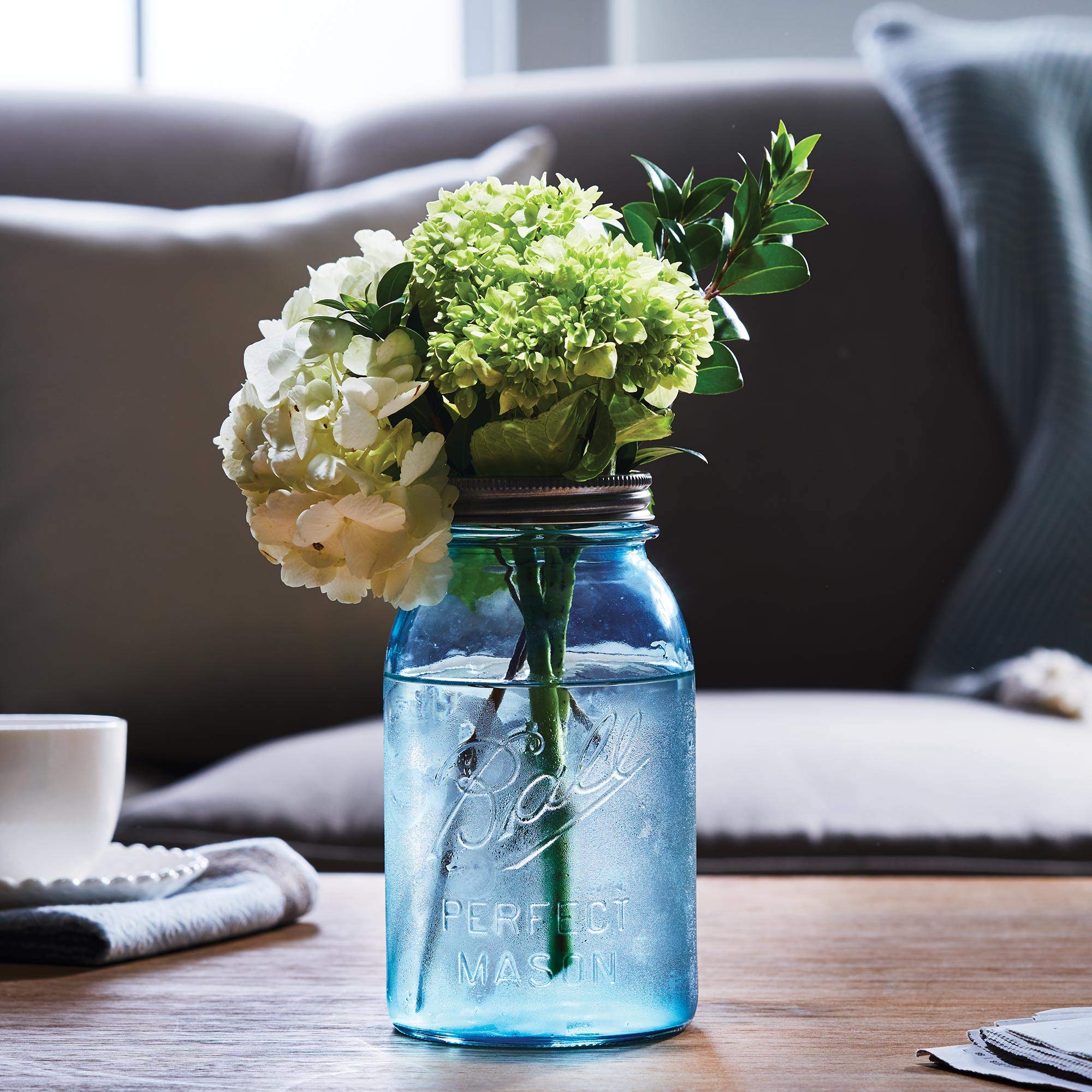 Ball vintage aqua glass showcases turn-of-the-century style in displays or crafts.