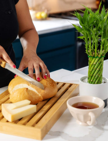 BAMBOO LAND crumb catcher catching crumbs during bread slicing
