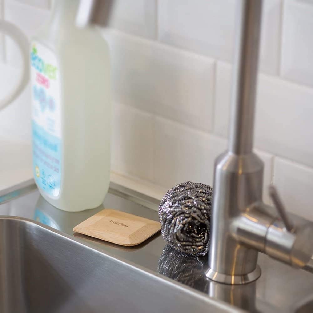 Bambu scraper close-up shows surface-protection and gentle contact with cookware.