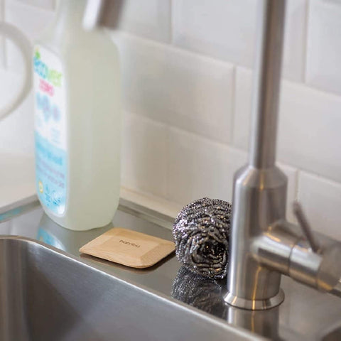 Bambu scraper close-up shows surface-protection and gentle contact with cookware.