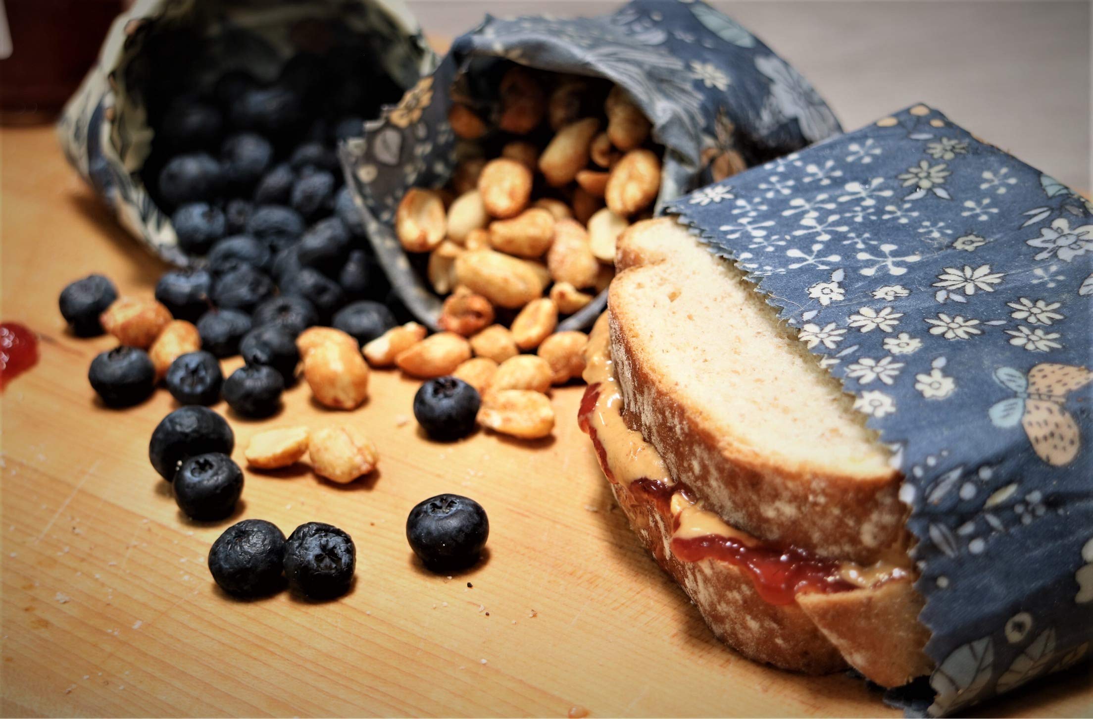 Bee Carefree beeswax wraps wrapping a sandwich for on-the-go use.