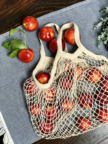 Bee Carefree produce bag with wooden buttons securing groceries.