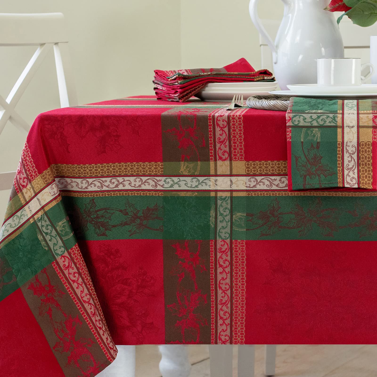 Benson Mills Holiday Legacy tablecloth with holly motif for festive gatherings.