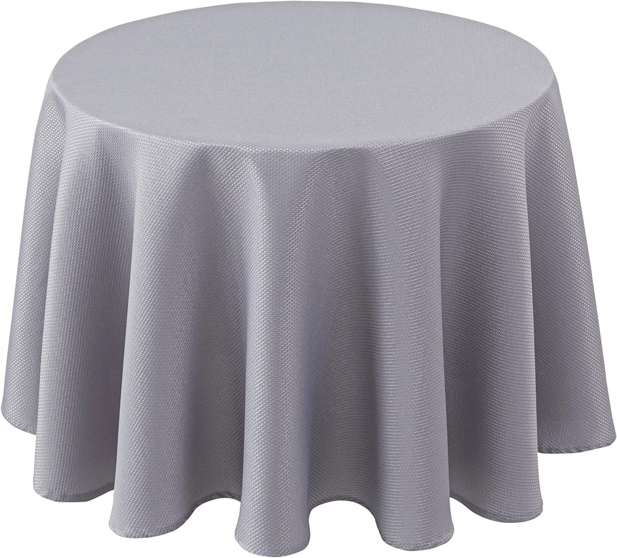 Biscaynebay textured round tablecloth in silver grey draped over a dining table