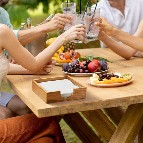 Bivvclaz Acacia wood napkin holder on outdoor table, durable for indoor and patio use.