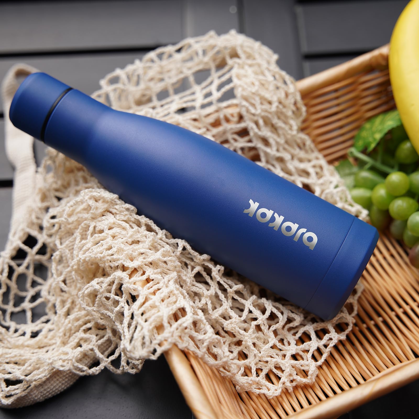 BJPKPK 25oz bottle in car cup holder illustrates its compact, travel‑friendly size.