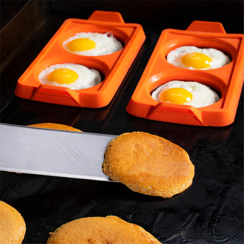 Blackstone egg rings used for pancake and patty molding on a griddle.