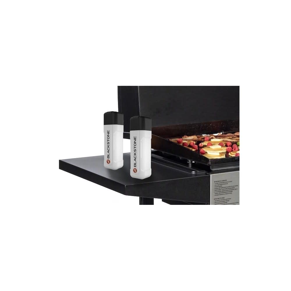 Blackstone squeeze bottle on grill vent for controlled glaze application.
