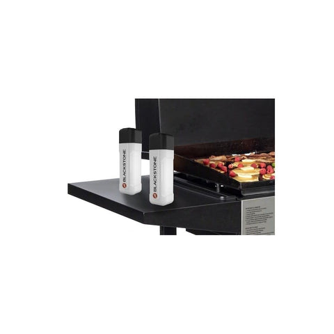 Blackstone squeeze bottle on grill vent for controlled glaze application.