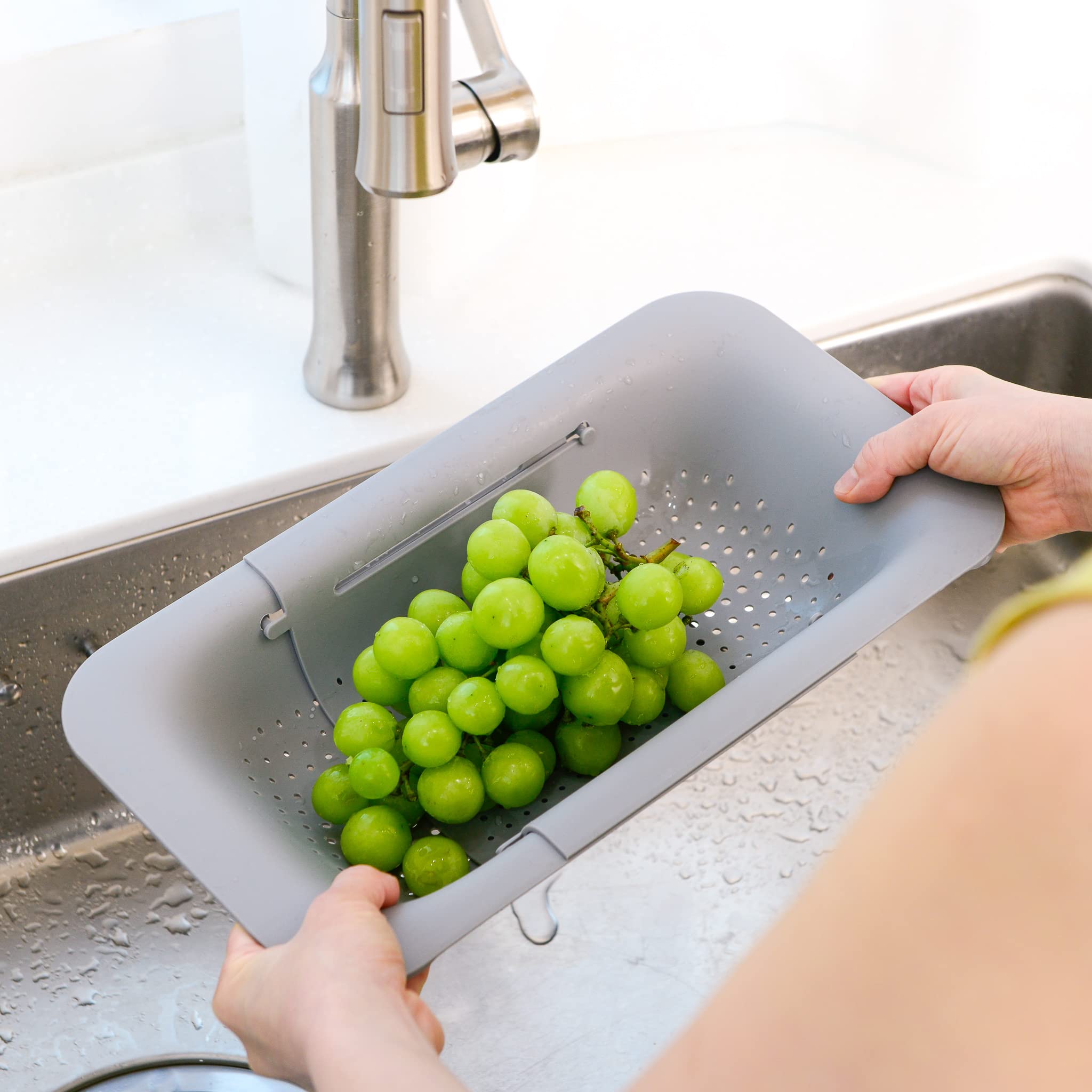 Blue Ginkgo extendable colander fits over sinks for flexible draining.