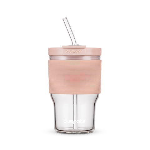 BluePOLAR glass juice bottle with pink sleeve, lid and straw for refreshing cold beverages.