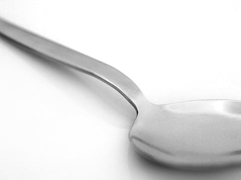 BNAZIND Kunz perforated spoon draining vegetables in a skillet