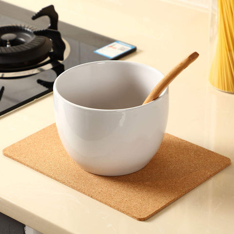 Boao cork trivet used as a placemat beneath a plate.