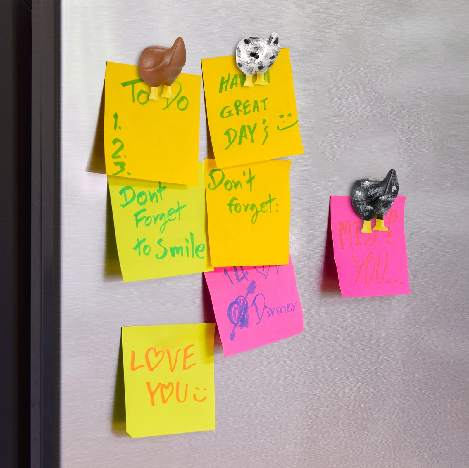 Bonuci chicken butt magnet in blue highlights notes on metal doors
