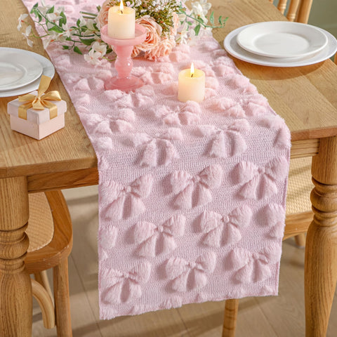 Breling pink bow table runner adds cozy faux fur texture to dining tables.