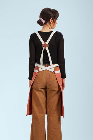 Caldo Split Leg Apron Terracotta crossback straps show adjustable, comfortable fit