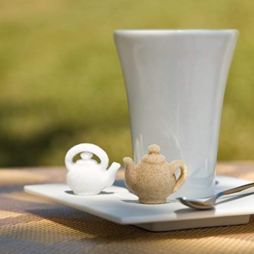 Canasuc teapot sugar pieces in white and amber displayed in a window box.