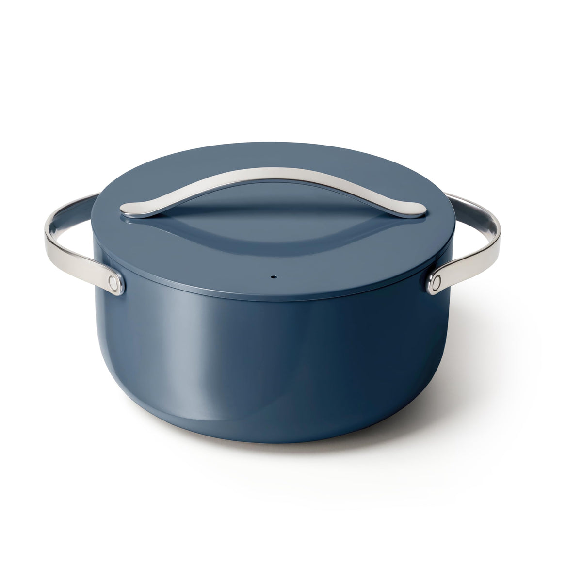 Caraway 6.5 qt navy Dutch Oven with lid, ideal for family roasts and one-pot meals.