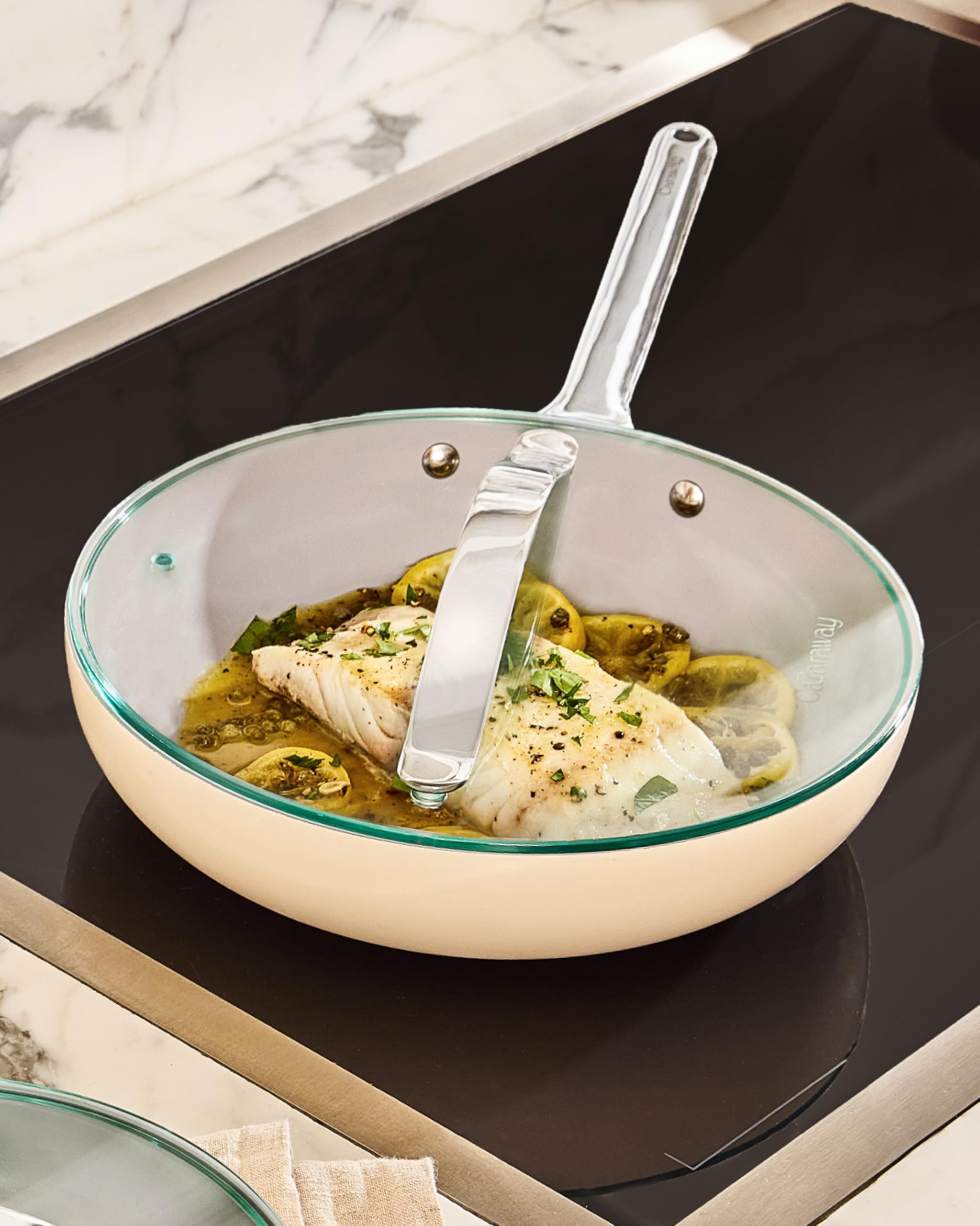 Caraway glass lid showing modern kitchen setup with compatible cookware.