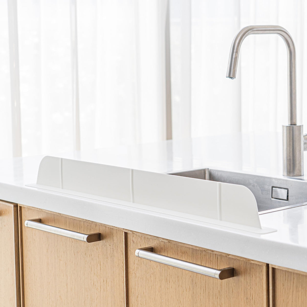 Casa Starlet 30-inch silicone splash guard on counter protecting clothes during dishwashing