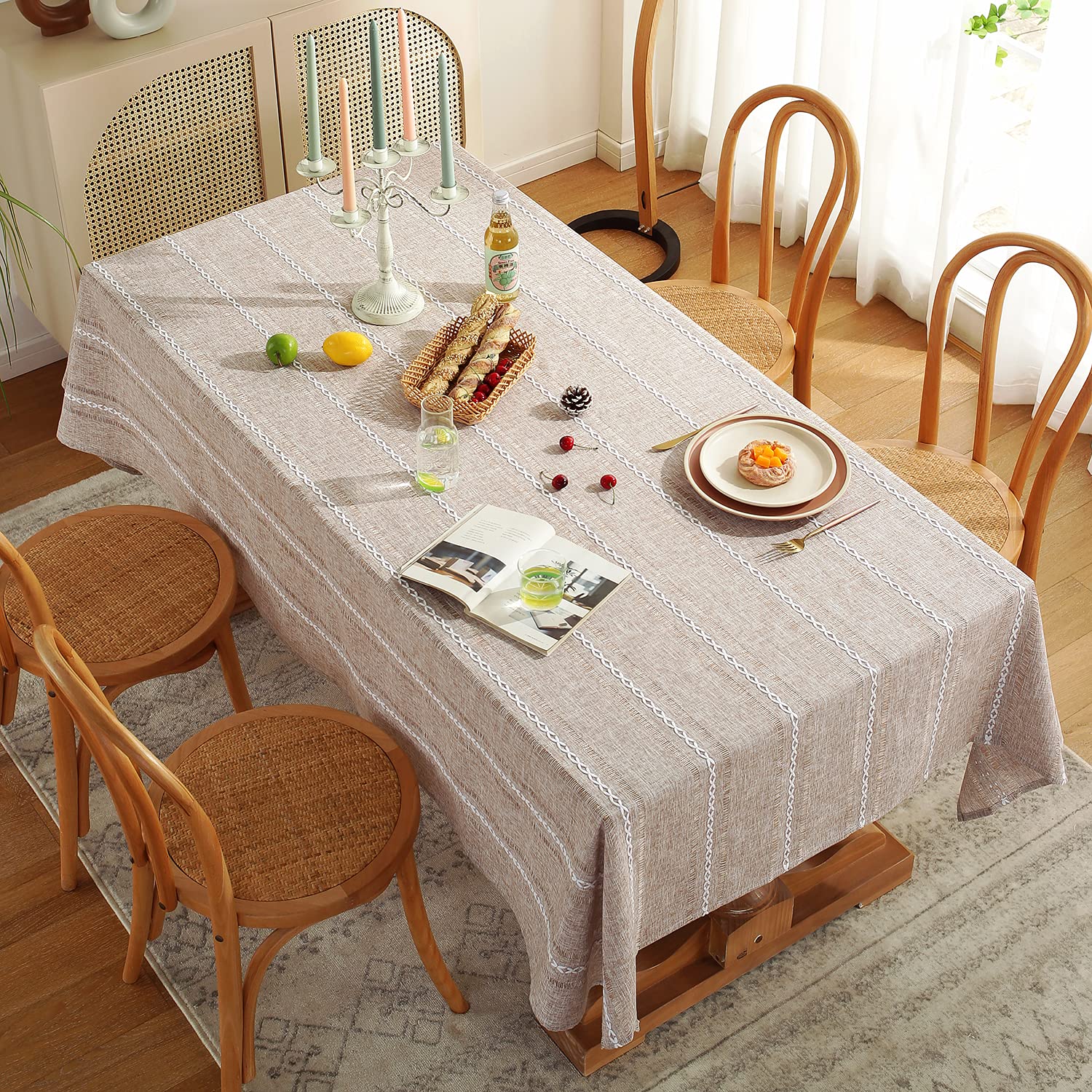 Chassic large rectangular tablecloth on a dining room table seating six to eight.