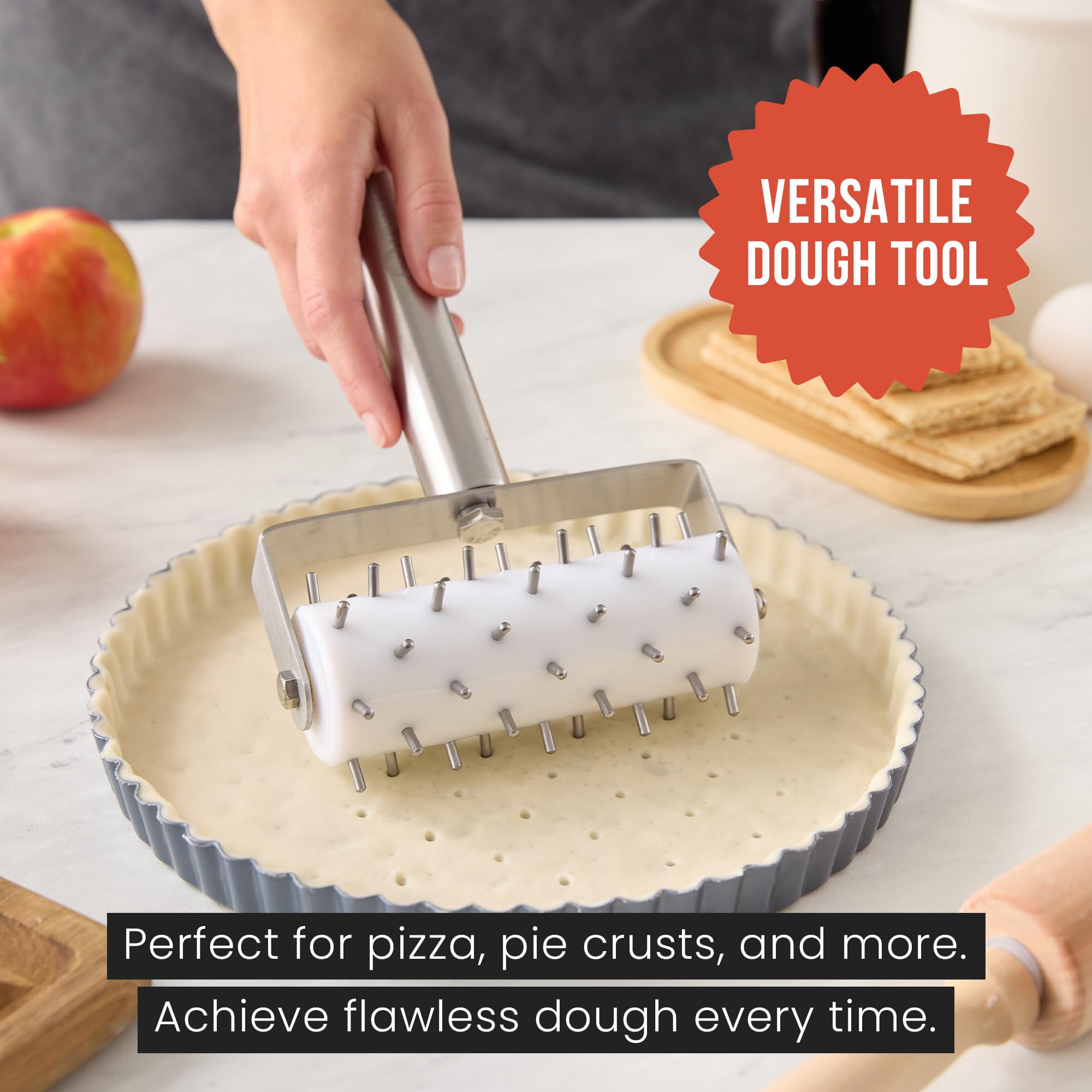 Chef Pomodoro black plastic dough docker roller with ergonomic handle.
