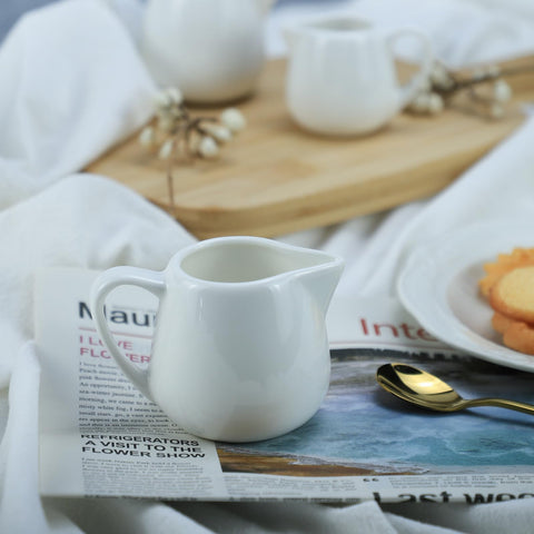 CHOOLD white ceramic creamer highlighting the comfortable grip handle.