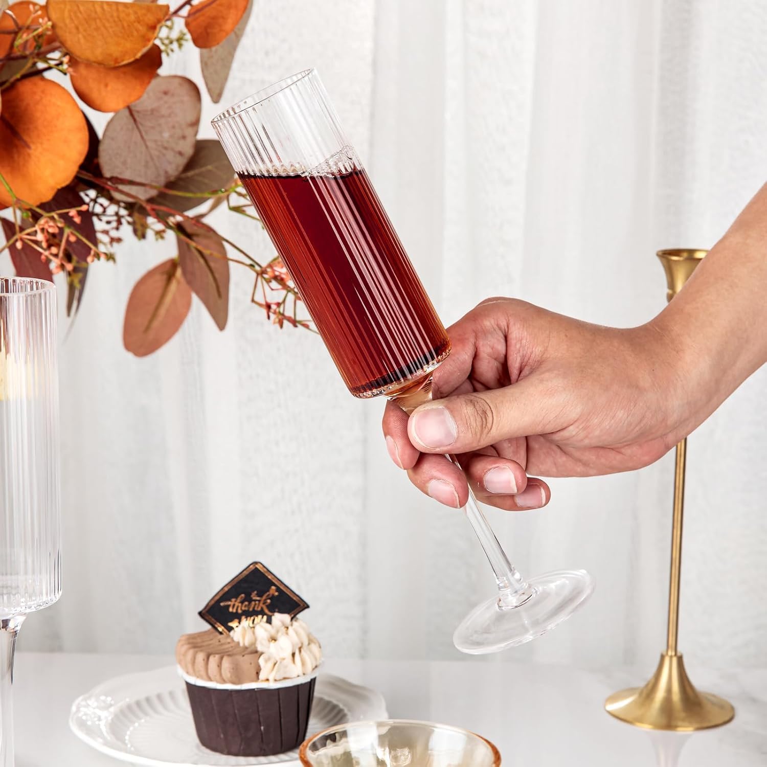 Ciaell toasts at a night party with elegant glassware