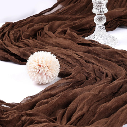 CKIKU brown cheesecloth table runner draped on table adds boho elegance for events.