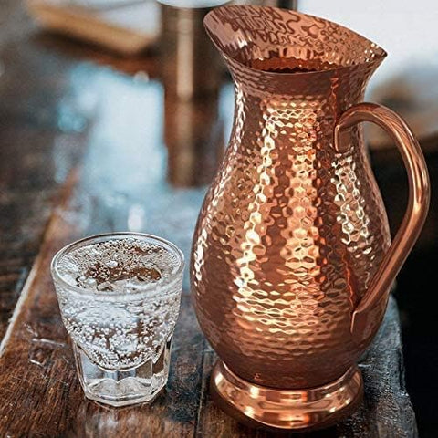 Classic Mules Copper Pitcher used as a vase adds warm metal accent.