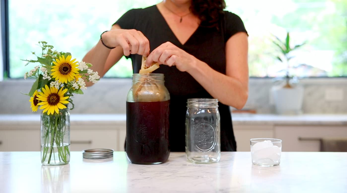 CoffeeSock filter in action during a cold brew pour for smooth results.